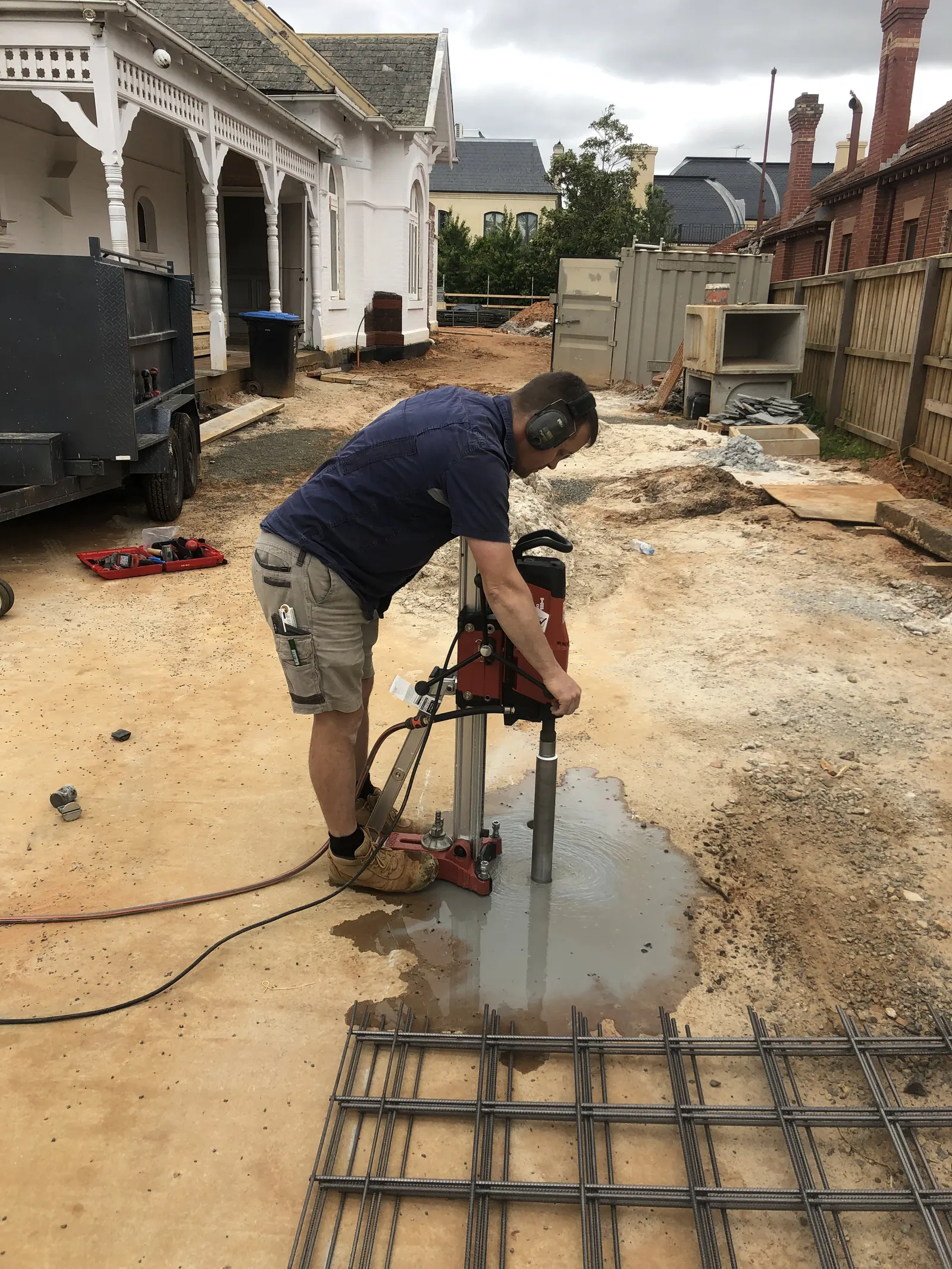 Warrick Dunn core drilling a concrete slab on a residential building site